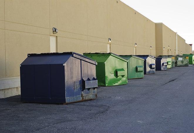 construction dumpsters stacked in a row on a job site in Sugar Creek